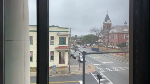 Interior Burke County Courthouse looking through a window at traffic downtown Stock Footage 148967705