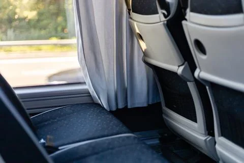 The interior of a bus features comfortable seating and privacy curtains. Su.. Stock Photos