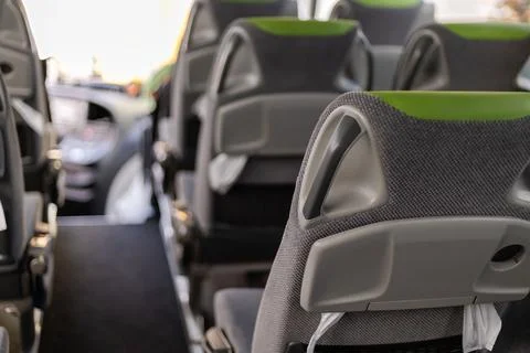 The interior of a bus shows rows of modern seats designed for comfort. Brig.. Stock Photos