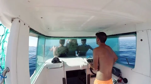 Interior of the cabin of a sailboat with the driver and a group of tourists Stock Footage 135020850