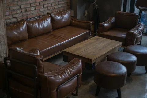Interior of cafe brown colours.Wool table, Leather brown sofa and chairs Stock Photos