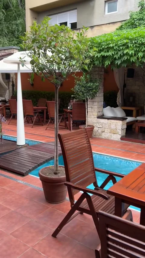 Interior of a cafe with a summer veranda and a swimming pool. There is a mug Stock Footage 279461377