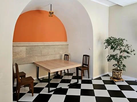 The interior of a cafe with a table for four persons in a sustained histori.. Foto stock