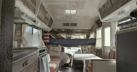 Interior of campervan and couple on the front seat Stock Footage 145281781