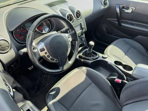 The interior of a car is displayed with a clear focus on the steering wheel,  Фото