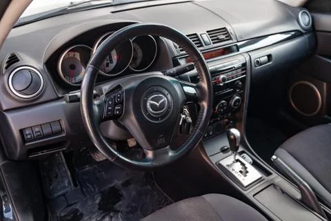 The interior of the car Mazda 3 with a view of the steering wheel, dashboard, Stock Photos