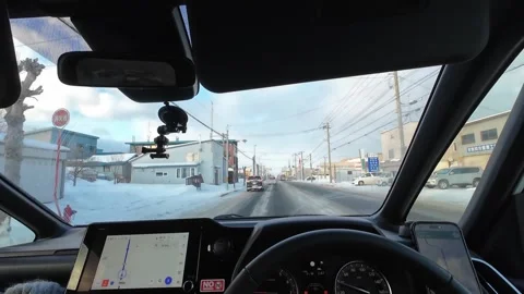Interior Car POV Winter Drive Past Traffic Lights In Furano Hokkaido Japan Stock Footage 333698993
