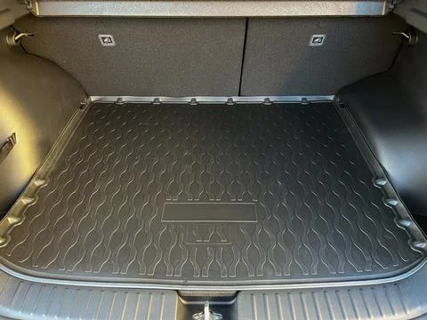 The interior of the car . Spacious car trunk with rubber mat Stock Photos