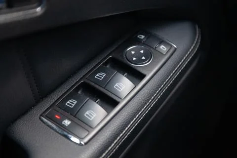 The interior of the car with a view of the driver door panel and windows swit Stock Photos