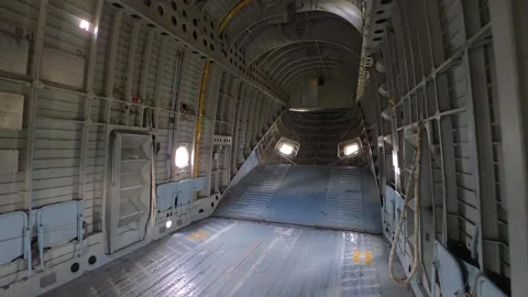 Interior cargo aircraft fuselage empty. Metal walls, exposed framework, and bare Stock Footage 344846230