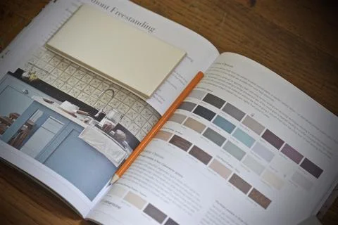 Interior catalog with tile sample and pencil on a wooden surface Stock Photos