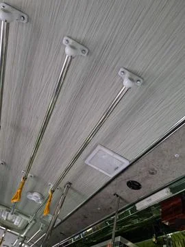 Interior Ceiling Grab Rails and Handles in Public Bus Stockfoto's