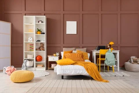 Interior of children's room with bed, study table and toys Stock Photos