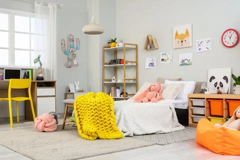Interior of children's room with bed, study table and toys Stock Photos