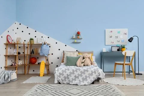Interior of children's room with study table, bed and shelf units Stock Photos