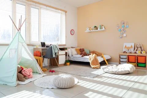 Interior of children's room with study table, bed and play tent Stock Photos