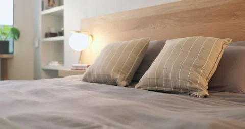 Interior, clean and bedroom at house with pillows, fresh linen and furniture for Stock Footage 337020295