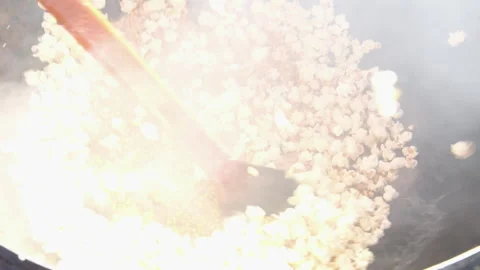 Interior close-up view of popcorn kernals rapidly exploding and rising toward Stock Footage 274317017