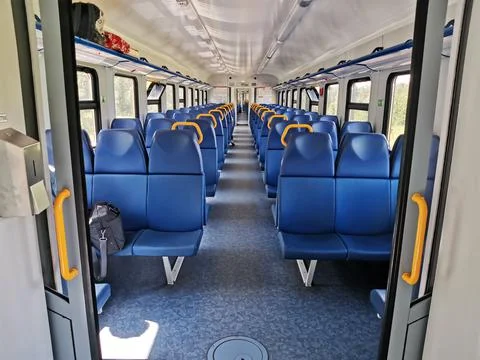 Interior coach commuter train. Train car inside. Absence of travelers passeng Stock Photos