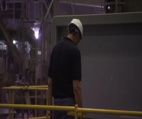 Interior coal power plant and machinery; Worker in hard hat Stock Footage 86694435