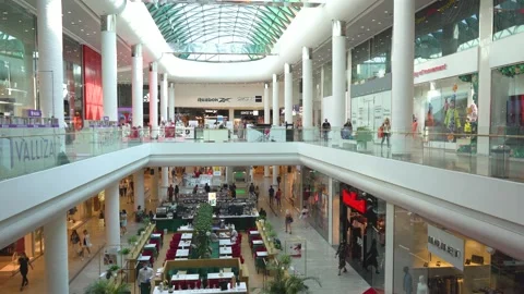 Interior with columns of modern shopping center, shops,cafes and restaurants Stock Footage 141877155