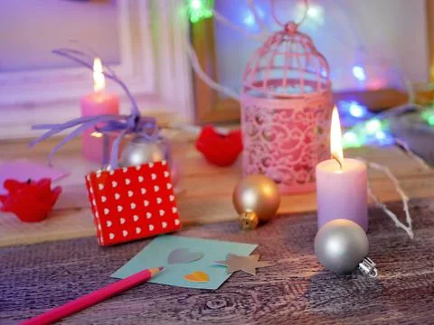 Interior composition of balls, lit candles, wooden frames, decorative lamps Stock Photos
