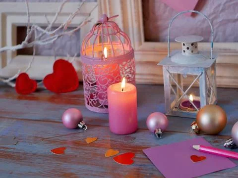 Interior composition of balls, lit candles, wooden frames, decorative lamps Stock Photos