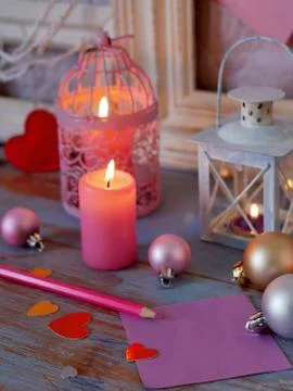 Interior composition of balls, lit candles, wooden frames, decorative lamps Stock Photos