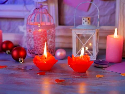 Interior composition of balls, lit candles, wooden frames, decorative lamps Stock Photos