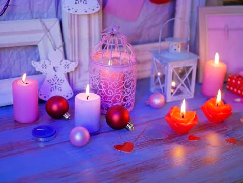 Interior composition of balls, lit candles, wooden frames, decorative lamps Stock Photos