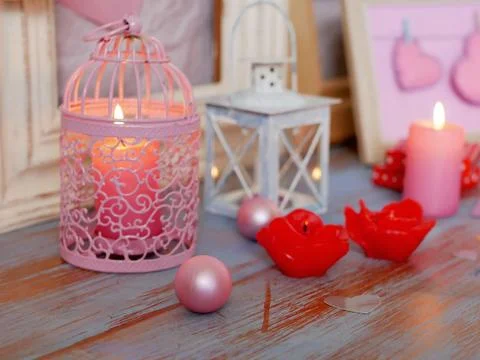 Interior composition of balls, lit candles, wooden frames, decorative lamps Stock Photos