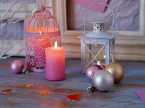 Interior composition of balls, lit candles, wooden frames, decorative lamps Stock Photos