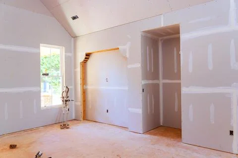Interior construction of room with drywall installed doorway in new home Stock Photos