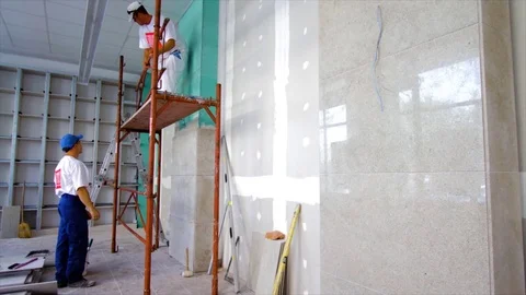 Interior Construction Time lapse. Fit marble tiles on the wall. Renovating Stock Footage 106609445
