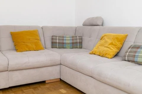 Interior corner soft sofa with yellow pillows Stock Photos