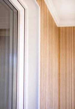 Interior corner with white window frame and striped wallpaper close up Stock Photos