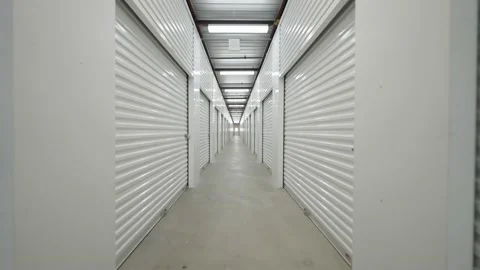 Interior of corridor self storage units at storage facility with locked doors Stock Footage 204831081
