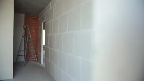 Interior corridor of unfinished building with brick and block walls Stock Footage 318411668