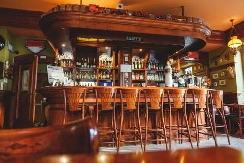 Interior of costly stylish bar, made of mahogany in the Irish pub Stock Photos
