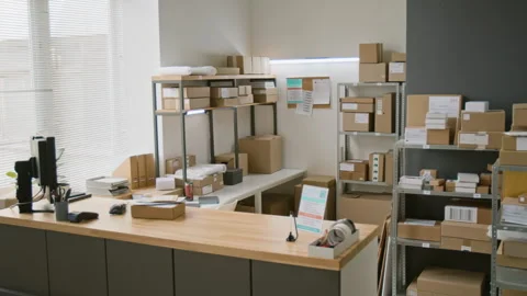 Interior of Courier Delivery Office with Racks of Parcels and Service Counter 스톡 동영상 321433709