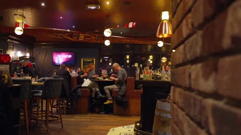 Interior of cozy pub restaurant in Paris France diners enjoying food and drinks Stock Footage 310180595