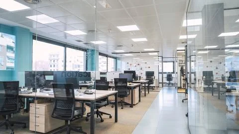 Interior of creative coworking workspace with computer desks Stock Photos