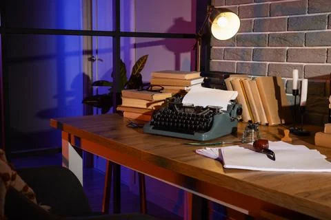 Interior of dark author's office with folding screen, vintage typewriter on d Stock Photos