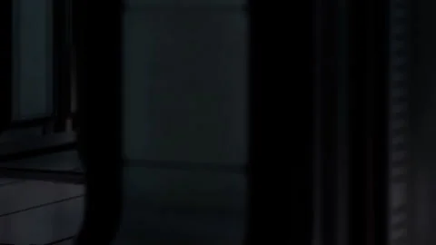 Interior of a dark corridor in an empty building with minimal lighting Stock Footage 344965594