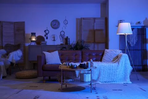 Interior of dark fortune teller's room with sofa, table and magic attributes Stock-Fotos