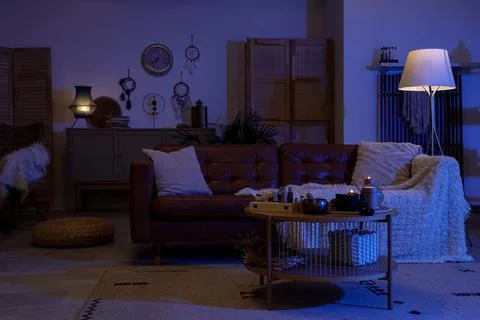 Interior of dark fortune teller's room with sofa, table and magic attributes Stock-Fotos