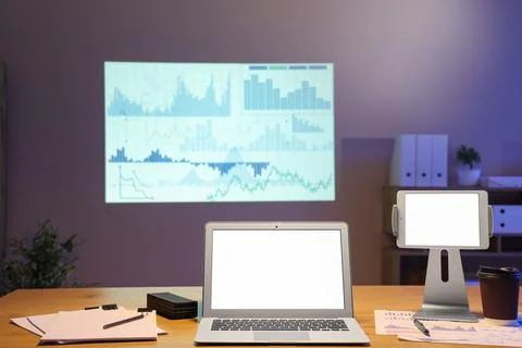 Interior of data scientists office with workplace, laptop, documents and diag Stock Photos