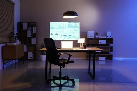Interior of data scientist's office with workplace, shelving units, laptop an Stock Photos