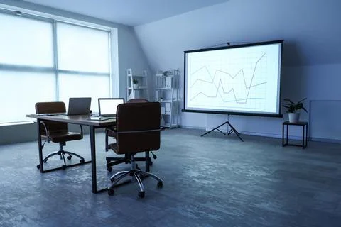 Interior of data scientist's office with workplace, laptops and diagrams on p Stock Photos