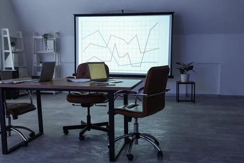 Interior of data scientist's office with workplace, laptops and diagrams on p Stock Photos